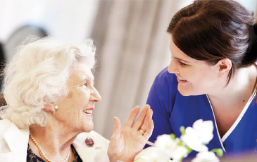Resident and carer speaking 