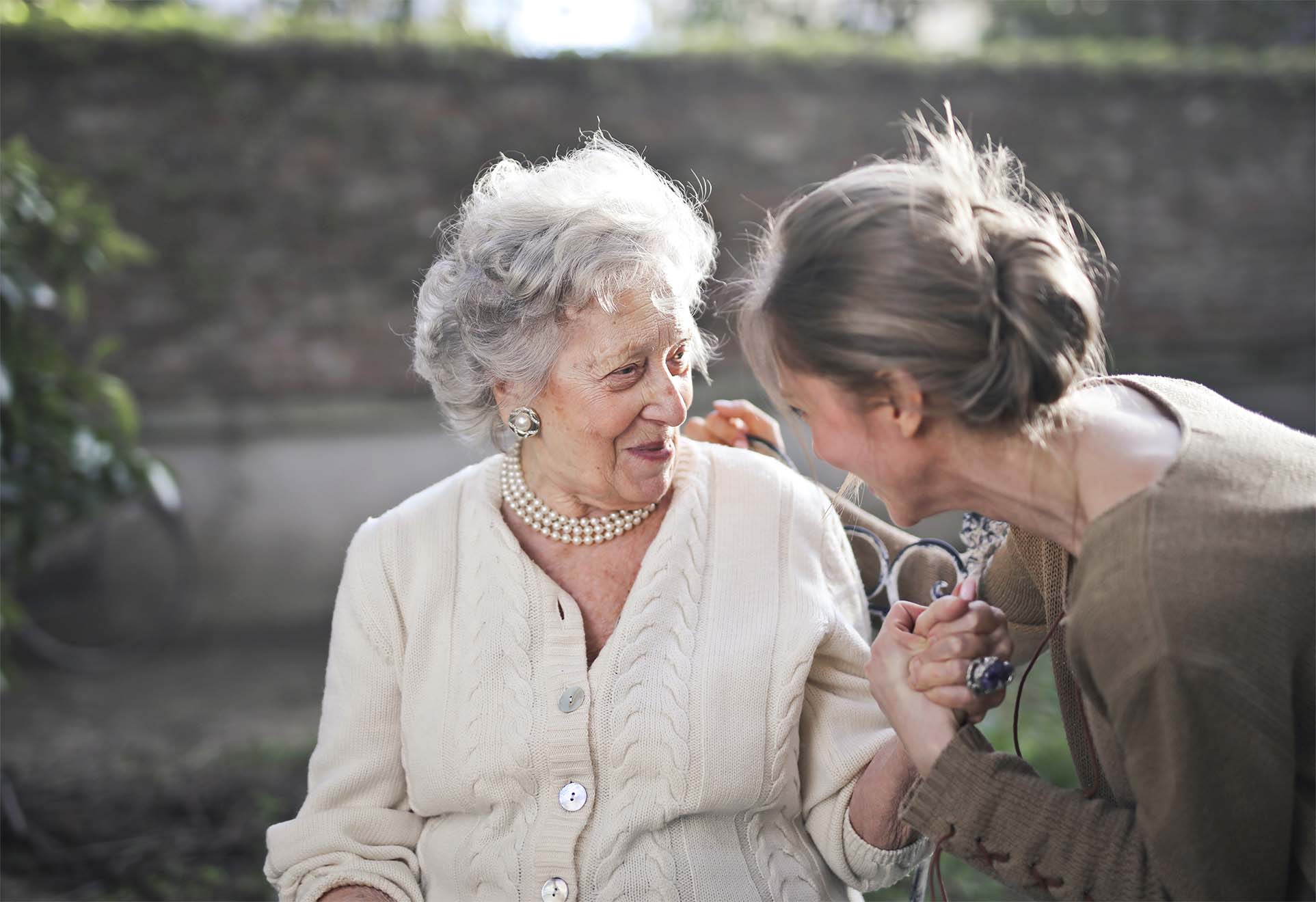 Resident sitting with family outside 