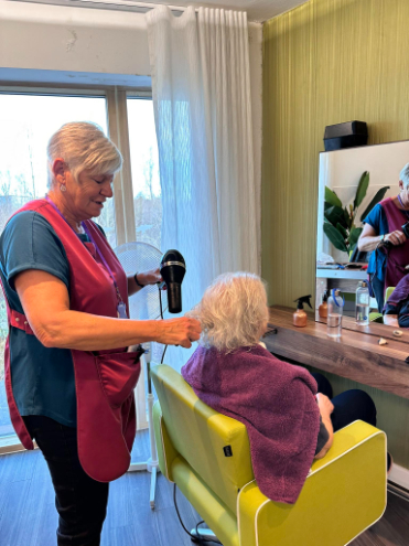 Resident having a blow dry in the salon