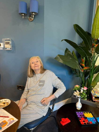 resident in pyjamas smiling for the picture enjoying Pyjama & Teddy Bear Day