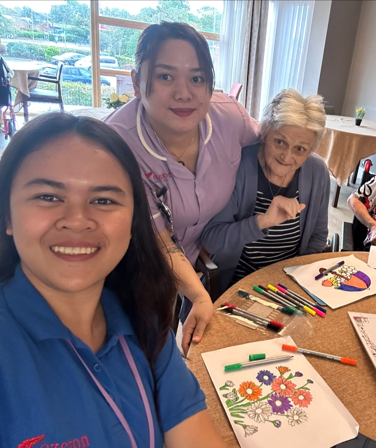 residents enjoying painting activity with staff at Casa di Lusso Care Home