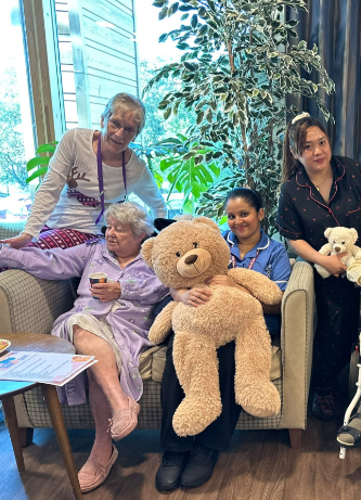 Residents holding teddy bears at Casa di Lusso Care Home