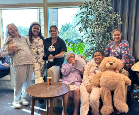 Residents wearing pyjamas and holding teddy bears at Casa di Lusso Care Home